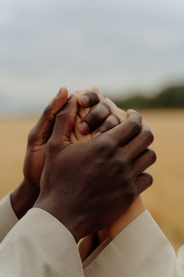 Close-Up Shot of Two People Holding Hands Together