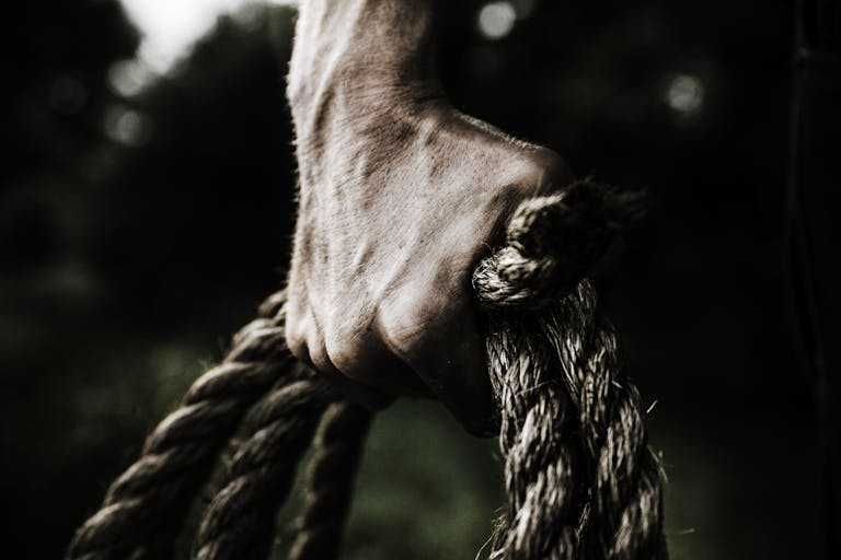 Man Holding Brown Rope